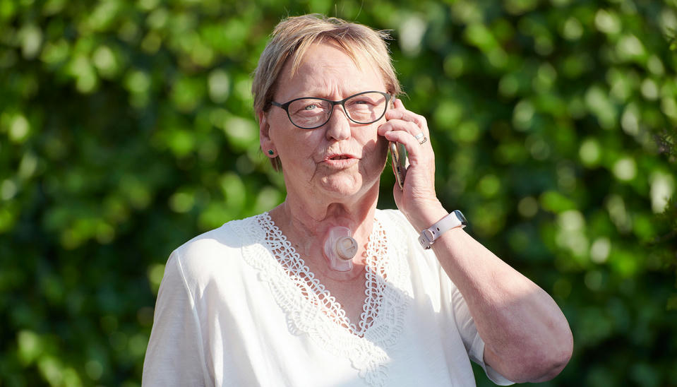woman using provox life freehands hme while talking on phone